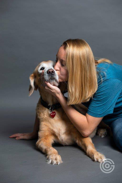 Image of Woman kissing a dog