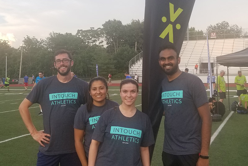 Group of four people wearing Intouch Athletics Tshirt