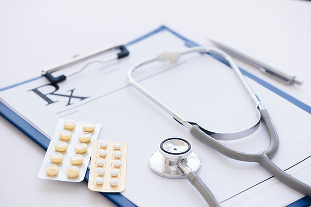 Stethoscope on clipboard with prescriptions