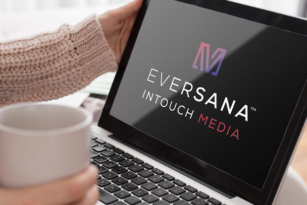 woman looking at loptop with EVERSANA INTOUCH media logo on screen