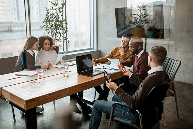 Diverse group of coworkers gathered around a conference room table