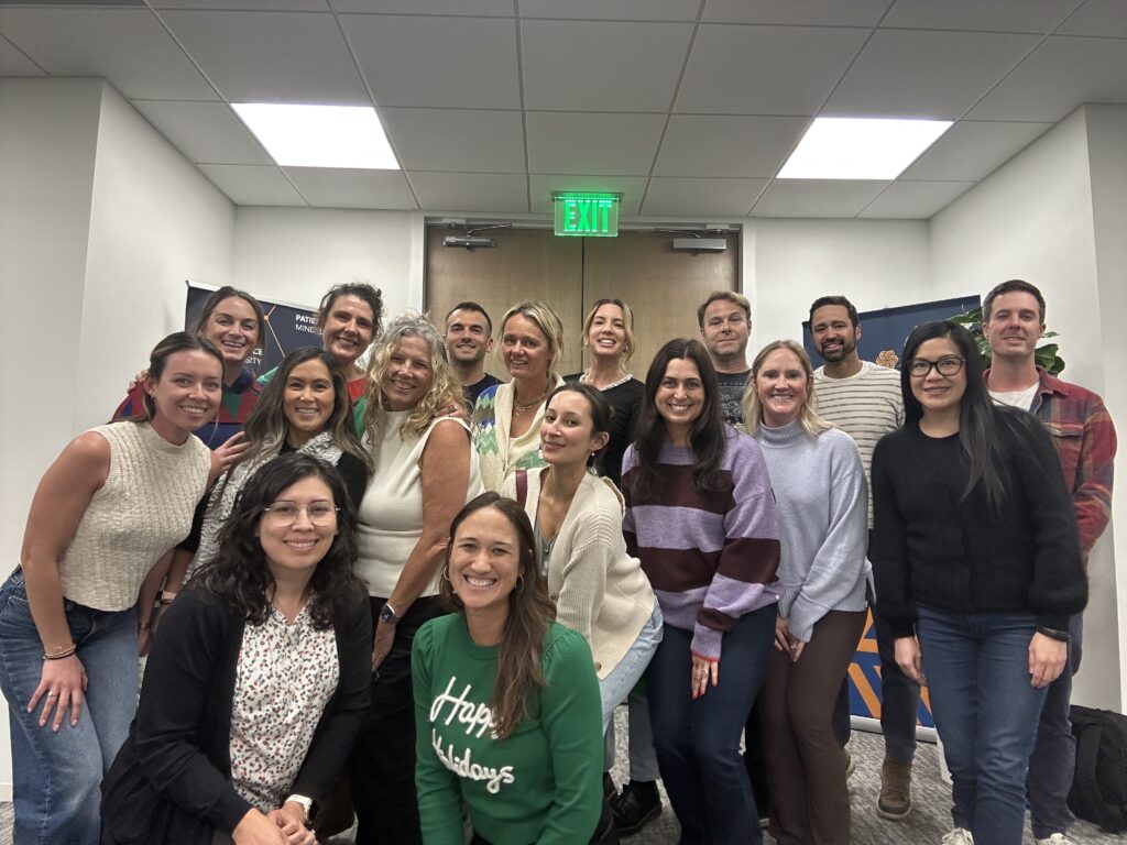 Employees posing for a photo at a company holiday event.